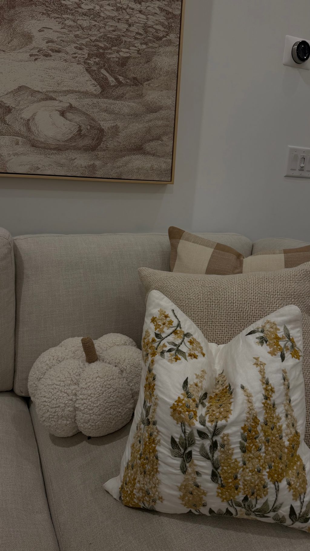 Decorating a warm neutral home for fall with golden autumn branches, pumpkins and classic seasonal decor.