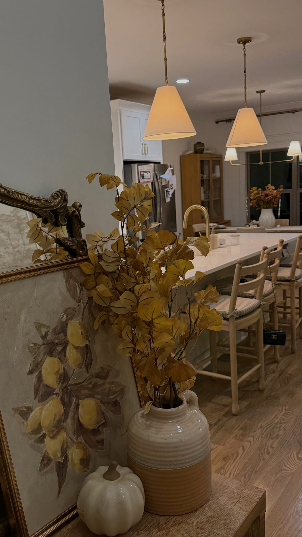 Decorating a warm neutral home for fall with golden autumn branches, pumpkins and classic seasonal decor.